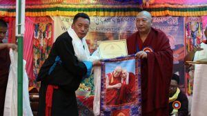 Secretary Dhondul Dorjee receiving a souvenir from the 34th Menri Trizin Lungtok Dawa Dargyal Rinpoche during the Consecration Ceremony of Shenten Youngdrung Lhatse Bon Monastery in Ladakh.